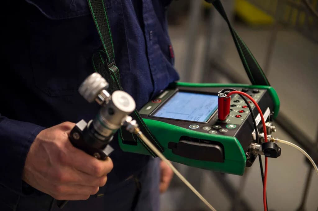 Technician calibrating pressure transmitter
